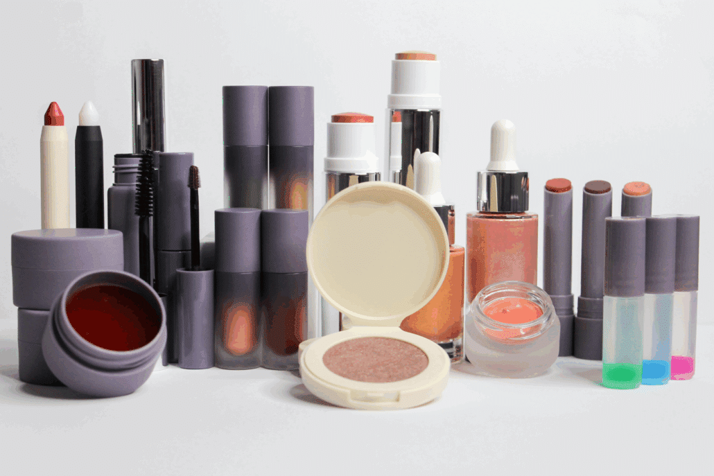 Colorful makeup: face sticks, blush, highlighter, eyeshadows, lip products.