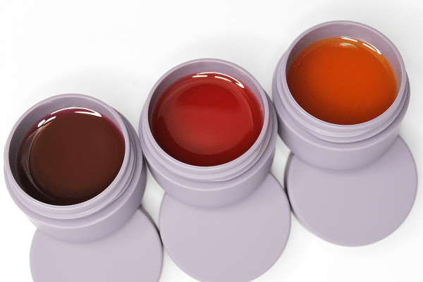 Three colored lip masks (purple, red and orange)