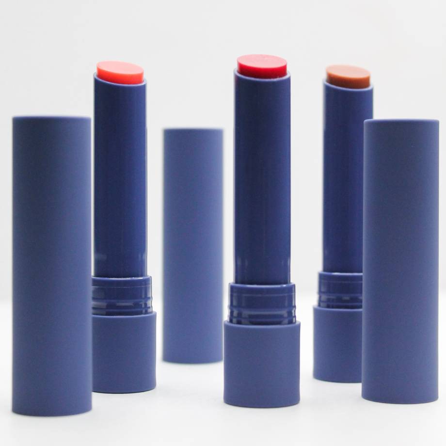 Blue lipstick tubes featuring coral, bold red, and nude tones.