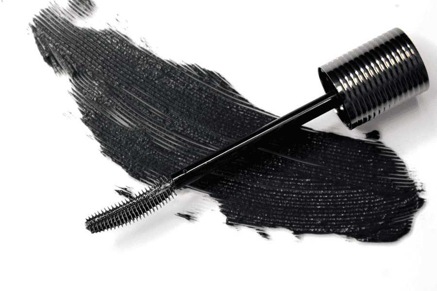 Elastomer mascara brush beside a black mascara formula swipe