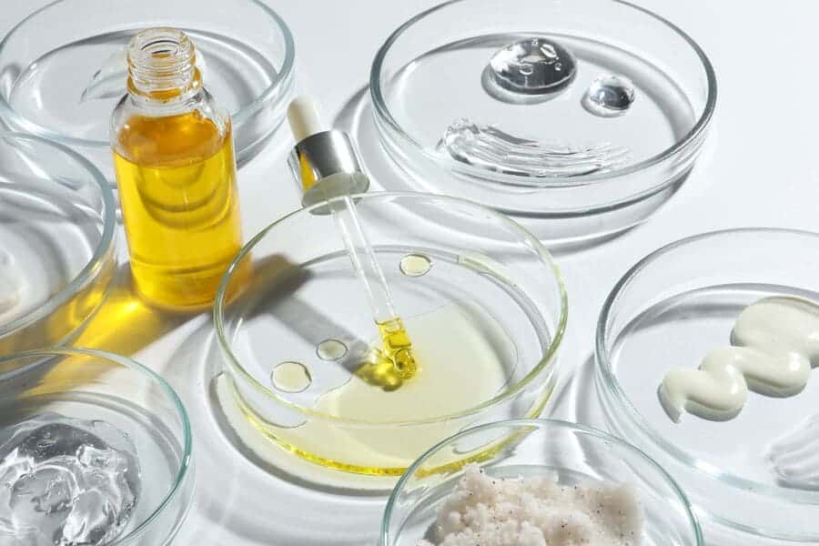 Cosmetic lab testing with oils, creams and serums in Petri dishes