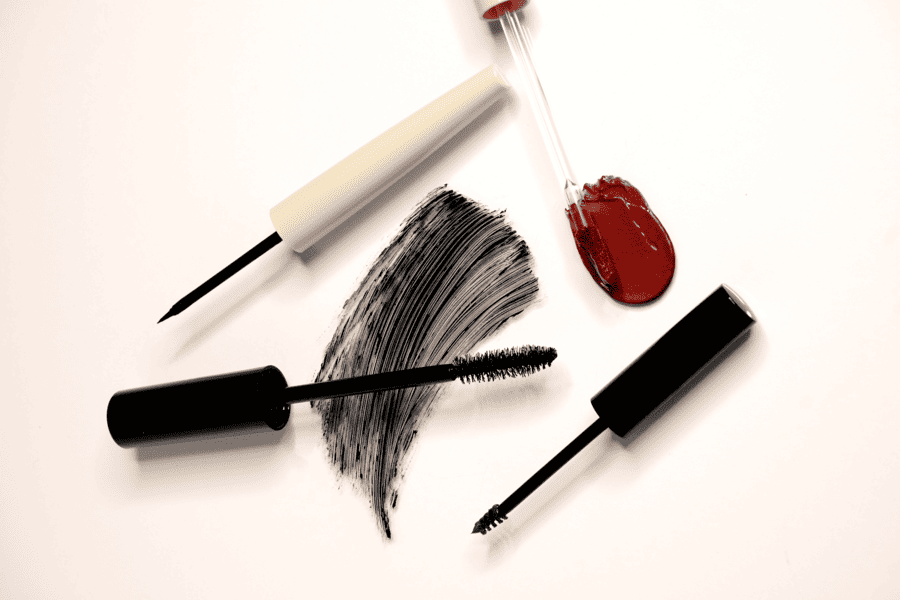 Mascara, eyeliner and liquid eyeshadow displayed with cosmetic applicators