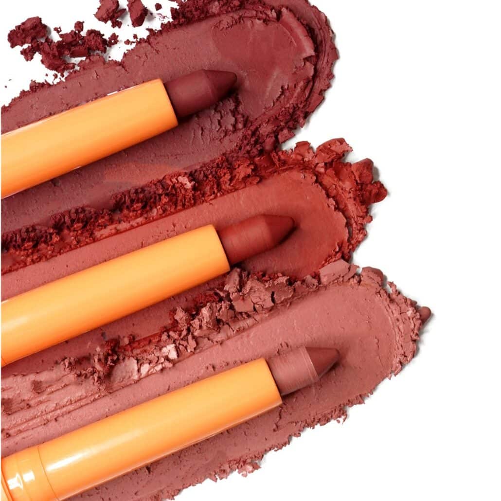 Three lipstick pencils on red and nude matte texture swatches